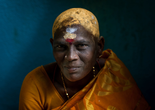 Portrait Of A Woman With Shaved Head Covered With Sandalwood Paste In Batu Caves During Annual Thaipusam Festival, Southeast Asia, Kuala Lumpur, Malaysia