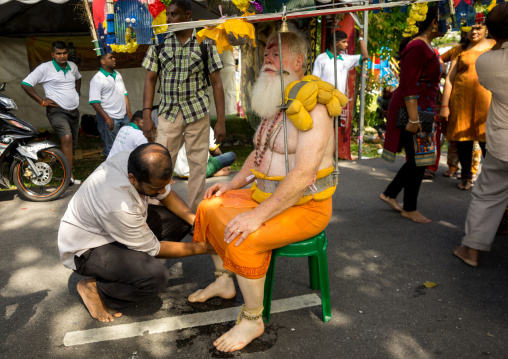 Man Putting Fresh Water On The Feet Of An Hindu Devotee In Annual Thaipusam Religious Festival In Batu Caves, Southeast Asia, Kuala Lumpur, Malaysia