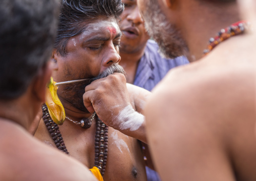 A Devotee Cheek Is Pierced Himself With A Skewer At Thaipusam Hindu Festival At Batu Caves, Southeast Asia, Kuala Lumpur, Malaysia