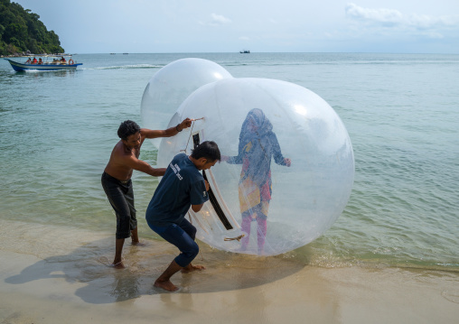 Muslim Tourist Inside A Water Walking Ball On Monkey Beach In Nan National Park, Penang Island, George Town, Malaysia