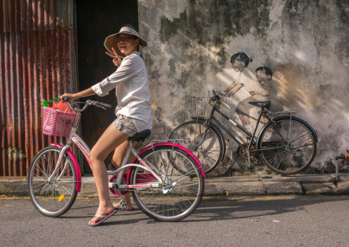 Tourist Posing For Photograph In Front Of A Street Arwotk By Lithuanian Artist Ernest Zacharevic, Penang Island, George Town, Malaysia