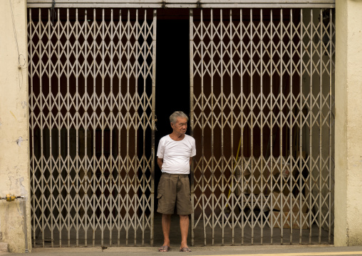 Man In Front Of A Closed Shop, Malacca, Malaysia