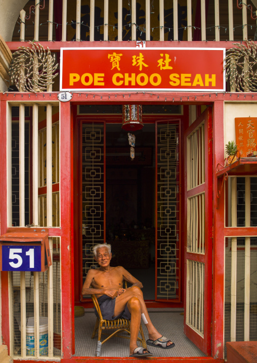 Old Man Sitting In Front Of His House In The Street, George Town, Penang, Malaysia