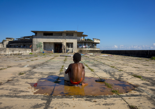 Kid Washing At The Top Of The Grande Hotel Slum, Beira, Sofala Province, Mozambique