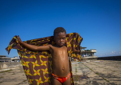 Kid Washing At The Top Of The Grande Hotel Slum, Beira, Sofala Province, Mozambique