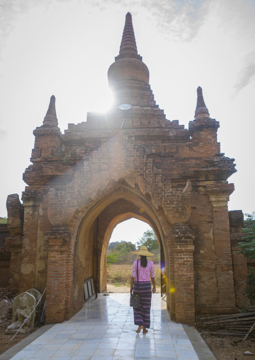 Woman Going Out Of An Old Temple Gate, Bagan, Myanmar