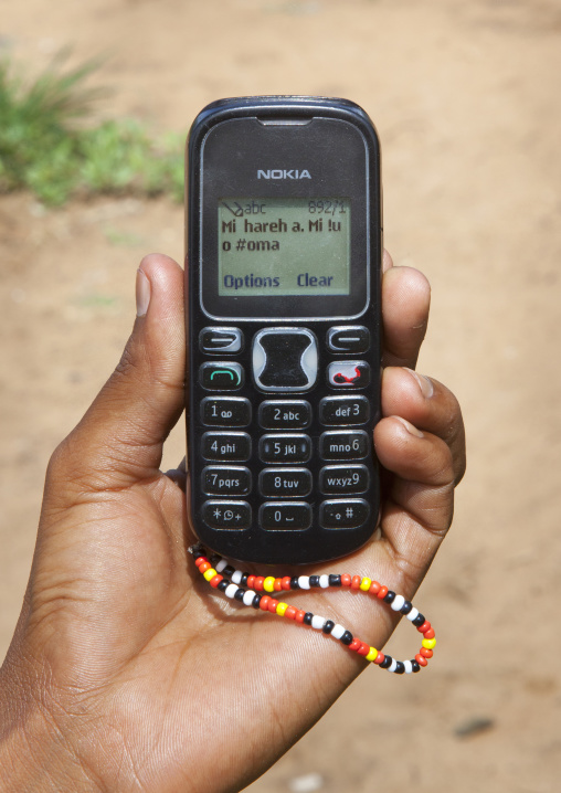 Bushman Showing A Text Message  In San Language On His Mobile Phone, Tsumkwe, Namibia