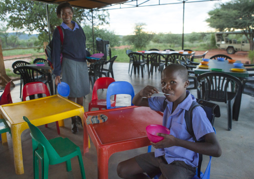 Child Eating At The Africat Foundation Canteen, Okonjima, Namibia