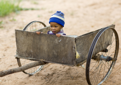 Bushman Child Boy In A Cart, Tsumkwe, Namibia