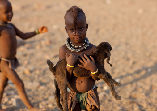 Himba Young Girl Holding A Lamb In Her Arms, Okapale Area, Namibia