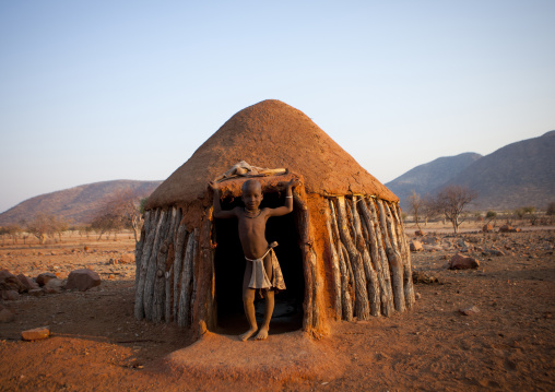 Himba Boy In The Entrance Of His Hut, Okapale Area, Namibia