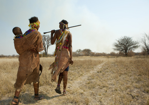 San Women Walking In The Bush With A Baby, Namibia