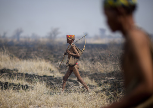 San Hunters Walking In The Bush After A Fire, Namibia
