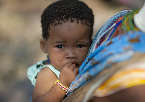 San Baby On The Back Of His Mother, Namibia