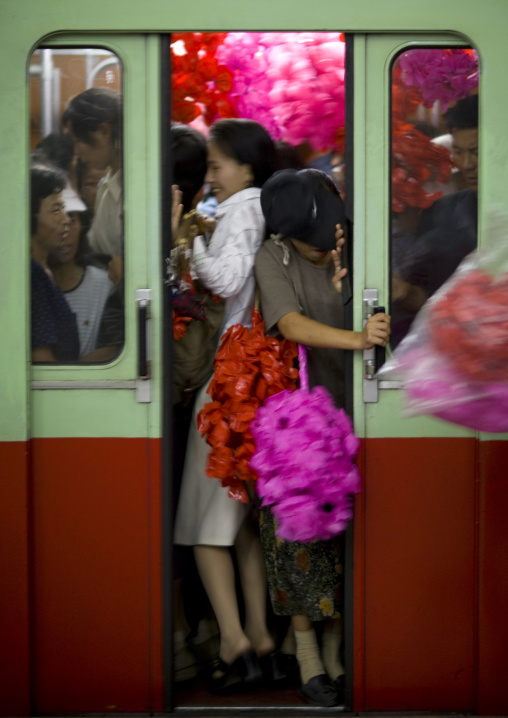 North Korean women with plastic flowers in the subway, Pyongan Province, Pyongyang, North Korea