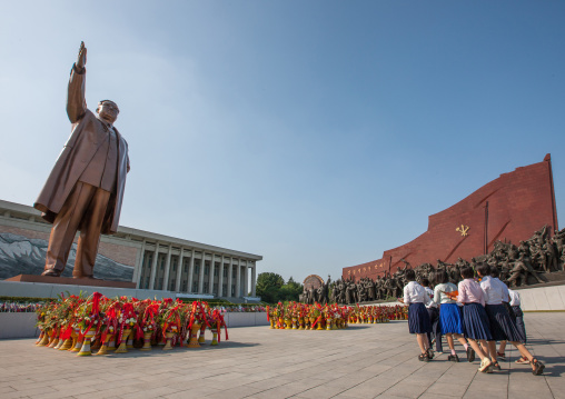 North Korean girls bringing flowers at the feet of Kim il Sung statue in Mansudae Grand monument, Pyongan Province, Pyongyang, North Korea