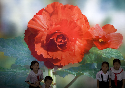 North Korean children under a Kimjongilia poster in the international Kimilsungia and Kimjongilia festival, Pyongan Province, Pyongyang, North Korea