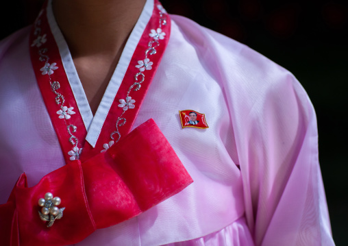 North Korean woman in pink choson-ot with a Kim il Sung badge, Pyongan Province, Pyongyang, North Korea