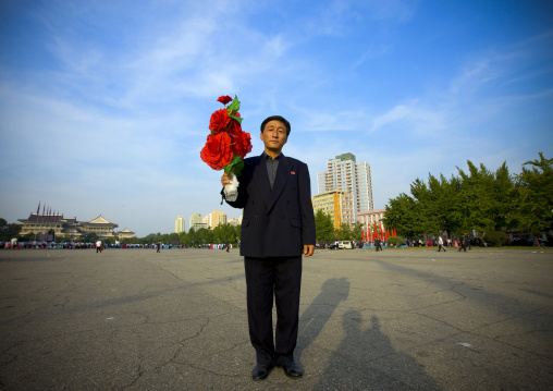 North Korean man with plastic flowers during the september 9 parade, Pyongan Province, Pyongyang, North Korea