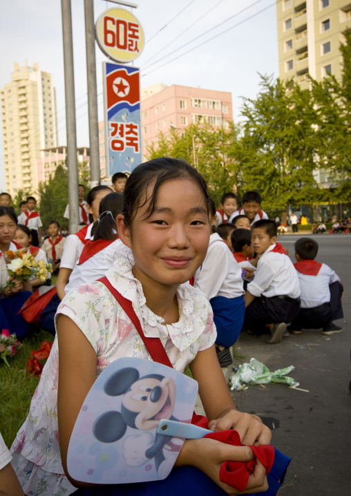 North Korean pioneer girl with a Mickey mouse fan, Pyongan Province, Pyongyang, North Korea