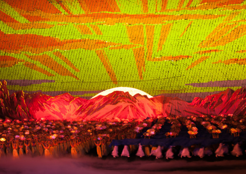 Rising sun over mount Paektu made by children pixels holding up colored boards during Arirang mass games in may day stadium, Pyongan Province, Pyongyang, North Korea