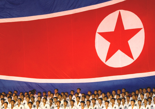 North Korean taekwondo team in front of a giant flag during the Arirang mass games in may day stadium, Pyongan Province, Pyongyang, North Korea