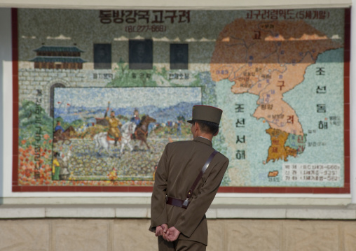 North Korean soldier looking at a Korea map in the street, North Hwanghae Province, Sariwon, North Korea