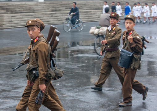 North Korean soldiers walking in the street with guns, North Hwanghae Province, Sariwon, North Korea