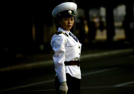 North Korean female traffic security officer in white uniform in the street, Pyongan Province, Pyongyang, North Korea