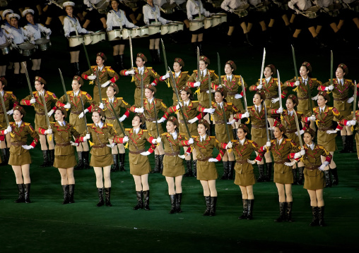 Sexy North Korean women dressed as soldiers dancing with swords during the Arirang mass games in may day stadium, Pyongan Province, Pyongyang, North Korea