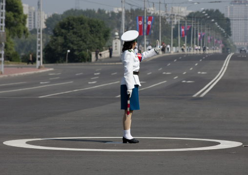 North Korean female traffic security officer in white uniform in the street, Pyongan Province, Pyongyang, North Korea