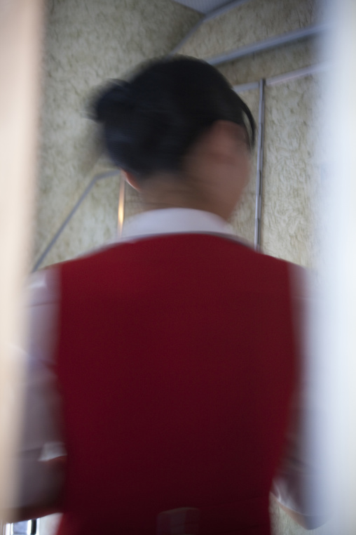 Rear view of a flight attendant woman from air Koryo, Pyongan Province, Pyongyang, North Korea