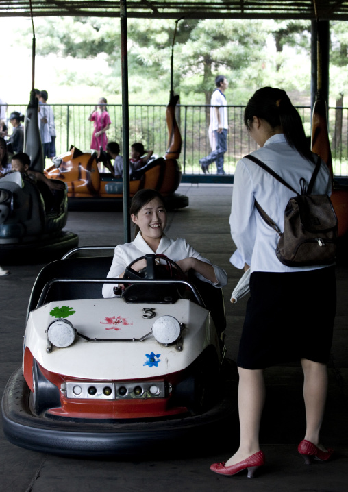 North Korean girls in bumper cars in Taesongsan funfair, Pyongan Province, Pyongyang, North Korea