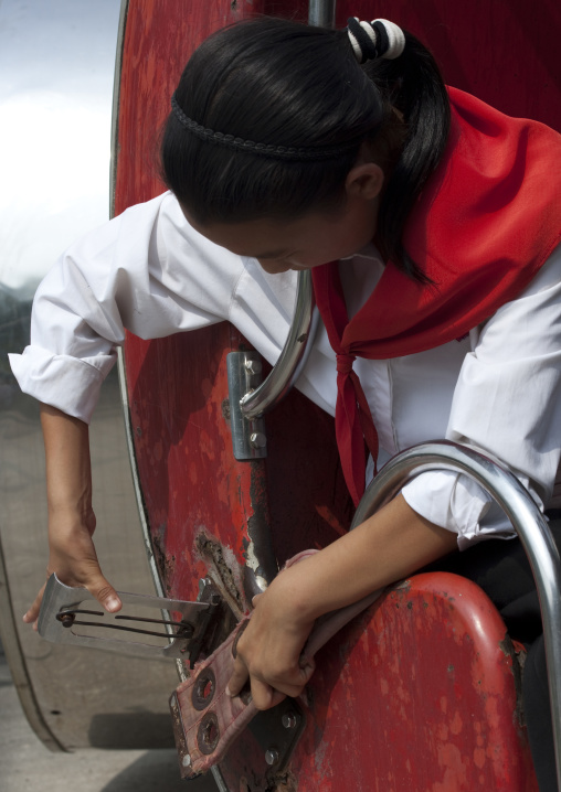 North Korean girl attaching her belt in an attraction in Taesongsan funfair, Pyongan Province, Pyongyang, North Korea