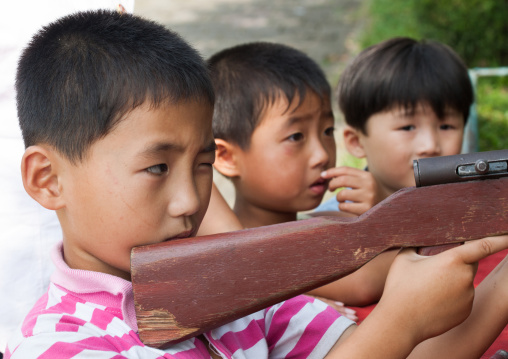 North Korean children shooting at Taesongsan funfair, Pyongan Province, Pyongyang, North Korea