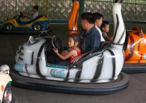 North Korean people having fun in bumper cars at Taesongsan funfair, Pyongan Province, Pyongyang, North Korea