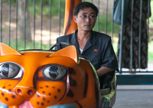 North Korean man in a bumper car at Taesongsan funfair, Pyongan Province, Pyongyang, North Korea