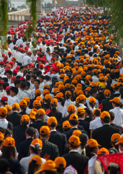 North Korean teenagers with yellow caps during the celebration of the 60th anniversary of the regim, Pyongan Province, Pyongyang, North Korea