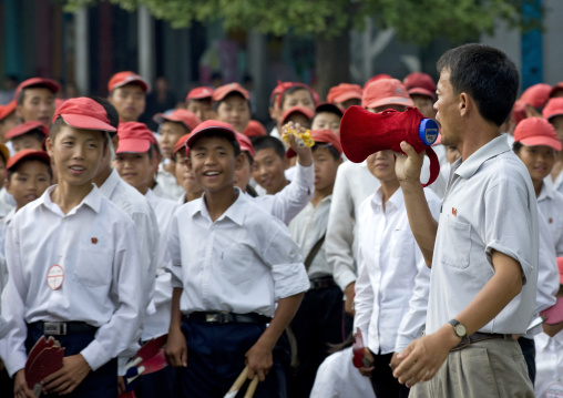 Smiling North Korean teenagers in the street going to a parade, Pyongan Province, Pyongyang, North Korea