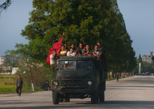 North Korean workers with a red flag at the back of a truck, North Hamgyong Province, Chilbo Sea, North Korea