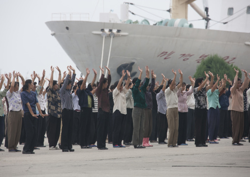 Women raising hands during morning exercise session, Kangwon Province, Wonsan, North Korea