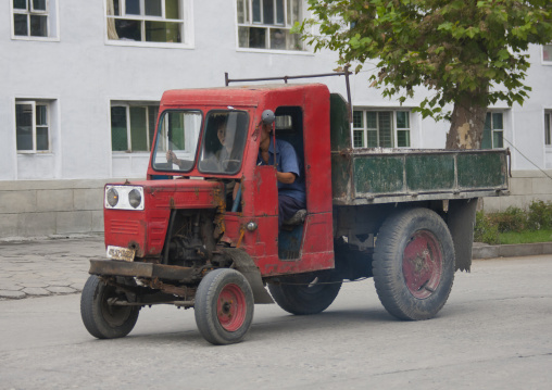 Old tractor driving on road, Kangwon Province, Wonsan, North Korea