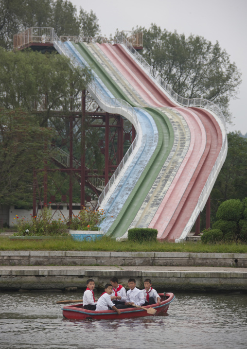 North Korean pioneers in a rowing boats in front of a water slide in Songdowon international children's union camp, Kangwon Province, Wonsan, North Korea