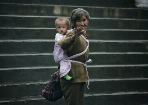 North Korean woman carrying a baby on her back, South Hamgyong Province, Hamhung, North Korea