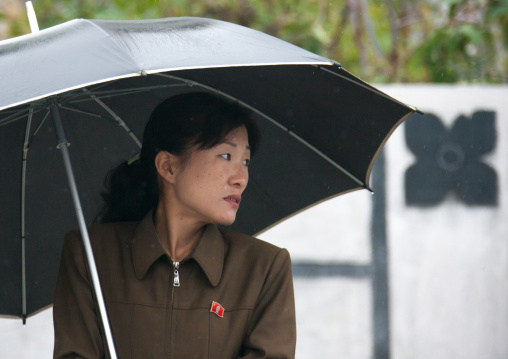 Portrait of a North Korean woman with an umbrella under the rain, South Hamgyong Province, Hamhung, North Korea
