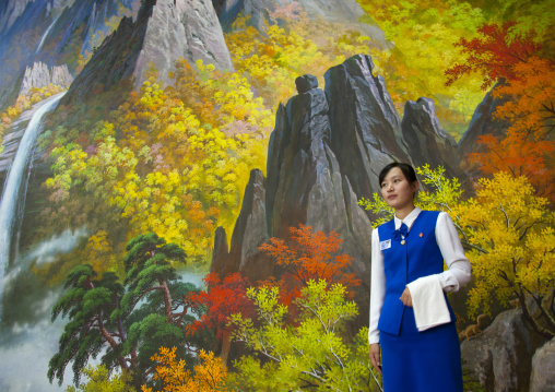North Korean waitress in front of nature painting in a restaurant, South Hamgyong Province, Hamhung, North Korea