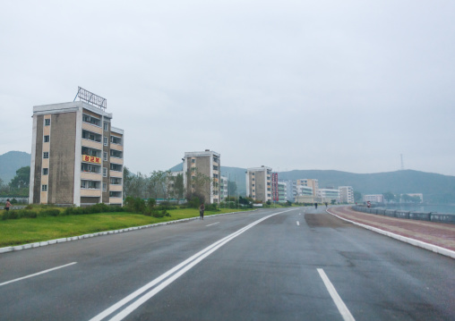 Fishermen apartments along an empty road, South Hamgyong Province, Hamhung, North Korea