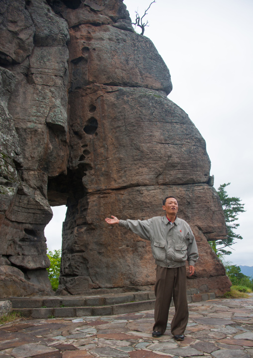 North Korean guide showing the famous wedding rock, North Hamgyong Province, Chilbosan, North Korea