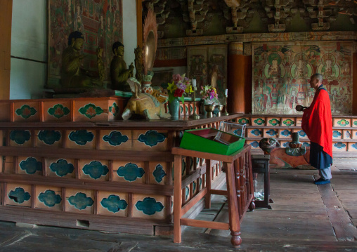 North Korean buddhist monk praying in kaesin sa temple on mount Chilbo, North Hamgyong Province, Chilbosan, North Korea