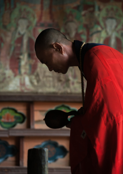 North Korean buddhist monk praying in kaesin sa temple on mount Chilbo, North Hamgyong Province, Chilbosan, North Korea